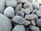 The stones at the shingle beach at the sea background