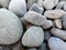 The stones at the shingle beach at the sea background