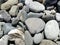 The stones at the shingle beach at the sea background