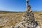 Stones stacked in balance in a pyramid shape in mountain landscape. Health and natural harmony concept