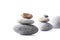 Stones stacked on top of each other and balanced on the white.