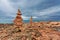 Stones stacks at rocks beach under gloomy sky