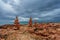 Stones stacks at rocks beach under gloomy sky