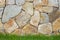 Stonework background with green grass