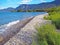 The stoney shores of Nikolaiika Beach on the Corinthian Gulf in Greece