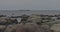 Stony Baltic sea shore cargo ship floats on the horizon in cloudy autumn weather