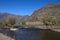 The stony banks of a mountain river are overgrown with shrubs. Altai, Siberia, Russia. Landscape