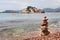 Stony beach on the Adriatic coast and against the background of the island - Hotel Sveti Stefan, Montenegro, Europe.