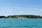 Stony Beach of Sirmione town on Garda Lake with view of Grottoes of Catullus.