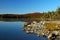 Stony beach and sunrise over beautiful lake