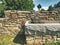 Stony fountain in nature with iron faucet.  Natural resources