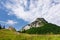 Stony peak and blue sky with clouds