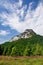 Stony peak and blue sky with clouds