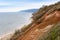 Stony, pebble and clay banks of the Volga River. Mountain slope of various stone rocks. Spring cloudy day with rain. Beautiful