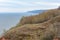 Stony, pebble and clay banks of the Volga River. Mountain slope of various stone rocks. Spring cloudy day with rain. Beautiful