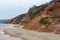 Stony, pebble and clay banks of the Volga River. Mountain slope of various stone rocks. Spring cloudy day with rain. Beautiful