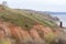 Stony, pebble and clay banks of the Volga River. Mountain slope of various stone rocks. Spring cloudy day with rain. Beautiful