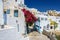 Stony road to Thira town among churches and traditional houses on Santorini island, Greece