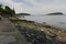 Stony shore with grasses and islets in the horizon at Agamont Park, Bar Harbor in Maine, USA