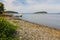 Stony shore with grasses and islets in the horizon at Agamont Park, Bar Harbor in Maine, USA