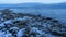 A stony shoreline by Lake MjÃ¸sa