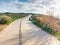 Stony tilled paved footpath at sea, dark stripe