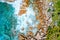 Stony tropical coastline with ocean waves on beautiful paradise like La Digue island, Seychelles. Aerial drone bird eye