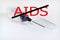 Stop aids. No drugs. Syringe with needle on light background. The needle in the protective cap