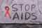 Stop Aids text hand write by black chacoal