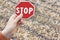 Stop asbestos concept image with hand holding a stop road sign against an asbestos roof