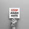 Stop Asian hate concept. hand holding card paper sheet with word stop Asian hate for poster of campaign