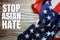 Stop Asian Hate text with USA flag on wooden background