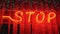 Stop blurry neon on red striped background with flickering small stars