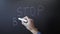 Stop bullying written on chalkboard. Hand writing stop bullying with chalk on blackboard. Stop harassment. Human rights