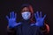 STOP coronavirus, black man shows with both hands the sign to stop, wearing a protective mask and gloves