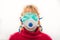 Stop coronavirus, old afraid woman wears 2 medical masks all over her face, tries to defend herself from Covid-19. With copy space