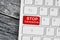 Stop coronavirus words on red button computer keyboard