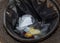Stop Covid 19. The end of coronavirus. People discard surgical protective face mask in a public trash bin. Dirty used medical mask