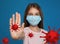 Stop Covid-19 outbreak. Little girl wearing medical mask surrounded by virus on blue background