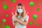 Stop Covid-19 outbreak. Woman wearing medical mask surrounded by virus on red background