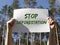 Stop deforestation inscription on paper in male hands. Save forests concept