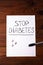 Stop Diabetes sign on a white paper sheet with sugar cubes on wooden background,prevention disease,detection diagnosis.