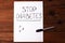 Stop Diabetes sign on a white paper sheet with sugar cubes on wooden background,prevention disease,detection diagnosis