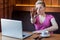 Stop doing it! Portrait of aggressive unhappy young girl freelancer with blonde short hair is sitting in cafe and having bad mood