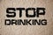 Stop Drinking. Creative composition with the message Stop Drinking on texturized grey grunge wall. Healthcare addiction prevention