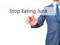 Stop Eating Junk - Businessman hand pressing button on touch screen interface.