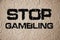 Stop gambling phrase sign on old texturized wall. Quit addiction concept on grunge background