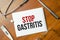 stop gastritis words on the white notepad. Medical concept