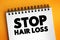 Stop Hair Loss text on notepad, medical concept background