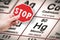 Stop heavy metals - Concept image with hand holding a stop sign against a mercury chemical element with the Mendeleev periodic